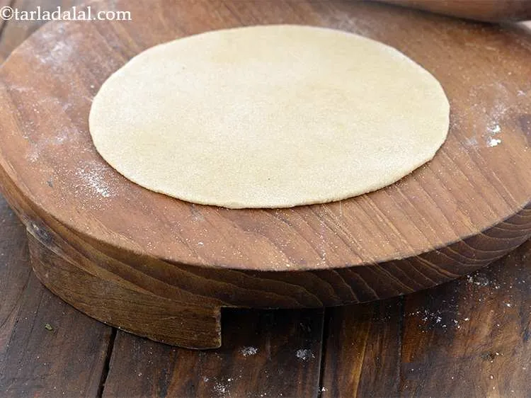 Step 17 – Roll a portion of the dough into a 150 mm. (6&rdquo;) diameter circle using a …