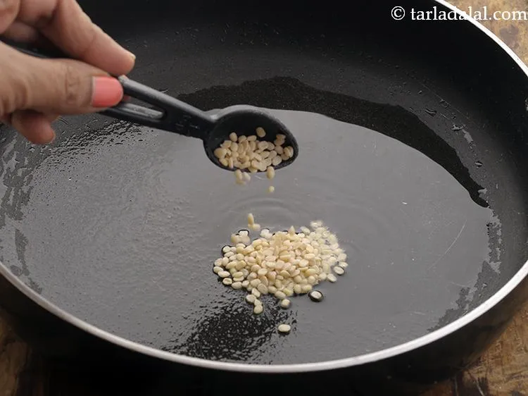 Step 11 – Add urad dal. Let it brown a little or else it will give a raw …