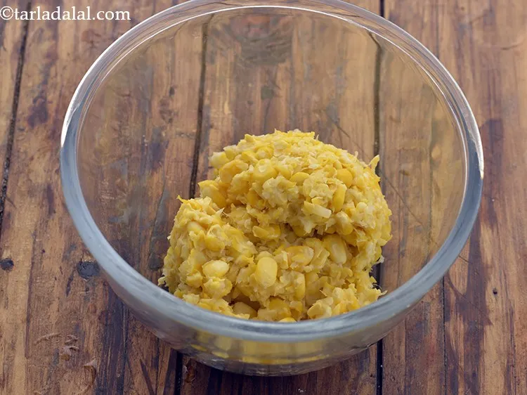 Step 10 – In a deep bowl,take the boiled and coarsely crushed sweet corn kernels.