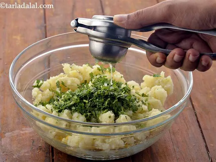 Step 15 – Add the lemon juice. It provides a chatpata flavor to the corn tikki mixture.