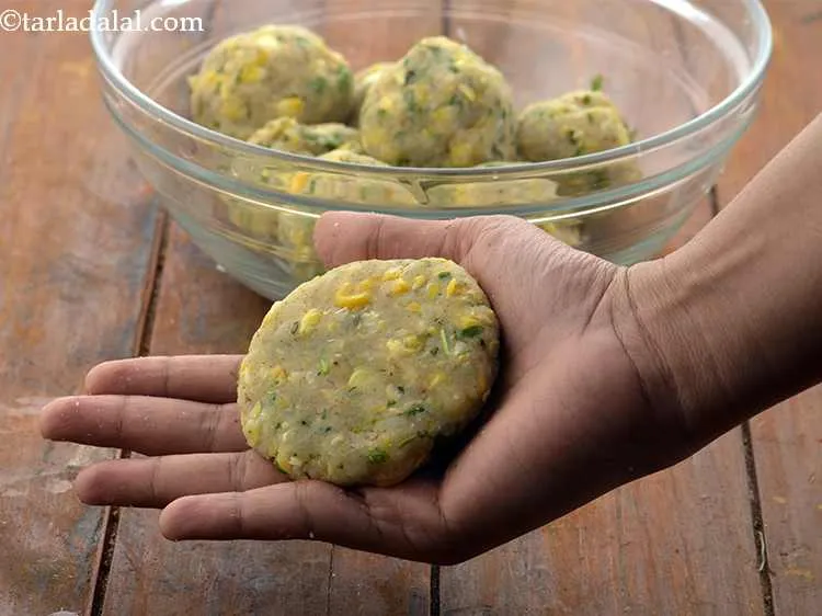 Step 23 – Then flatten it lightly between your palms to make a 75 mm. (3&rdquo;) diameter tikki.