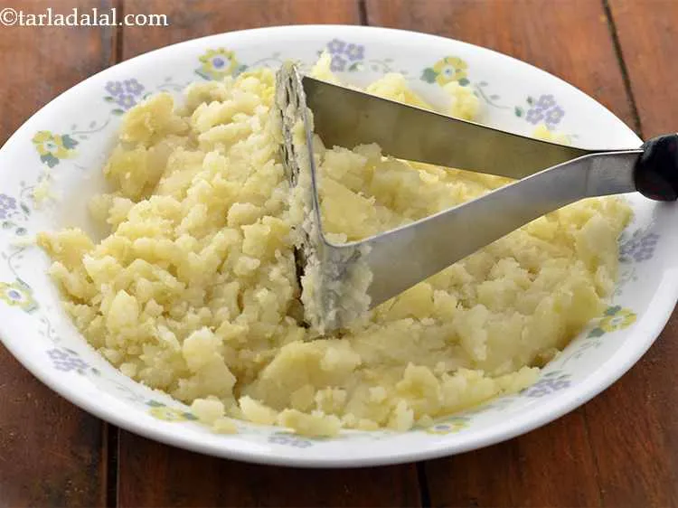 Step 5 – Mash them lightly using a potato masher or grate them and keep aside.