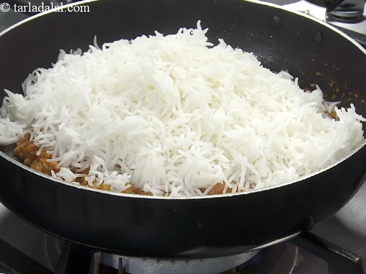 Step 31 – Add 3 cups&nbsp;<a href="https://www.tarladalal.com/cooked-rice-32639r">cooked rice</a>.