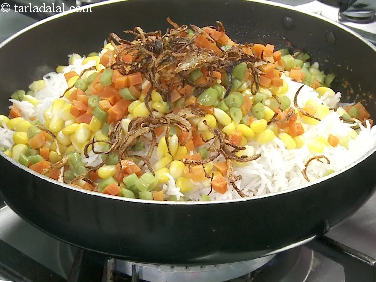 Step 34 – Add 1/4 cup&nbsp;<a href="https://www.tarladalal.com/glossary-fried-onions-924i">deep-fried onions</a>.