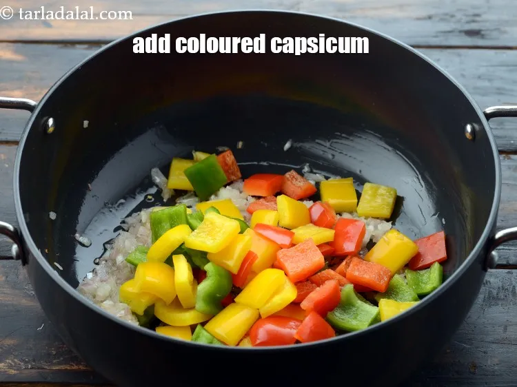 Step 13 – Add 1 cup coloured&nbsp;<a href="https://www.tarladalal.com/glossary-capsicum-cubes-170i">capsicum cubes</a>&nbsp;(red , yellow and green).&nbsp;