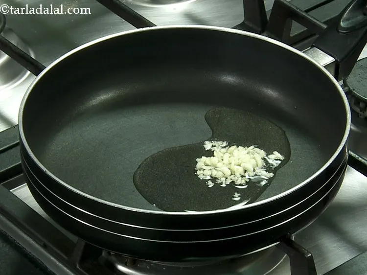 Step 13 – Once the oil is moderately hot, add the garlic.