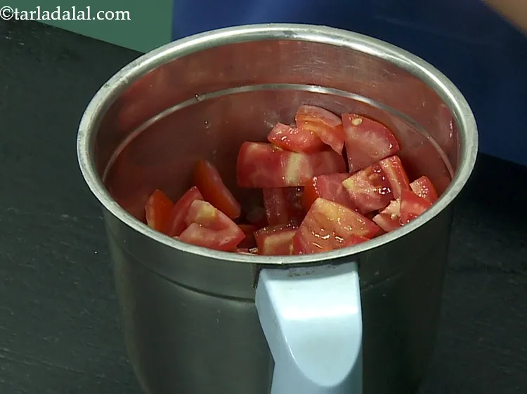 Step 24 – For the tomato sauce of <strong>fresh corn enchiladas</strong>, transfer the tomatoes in a mixer jar.