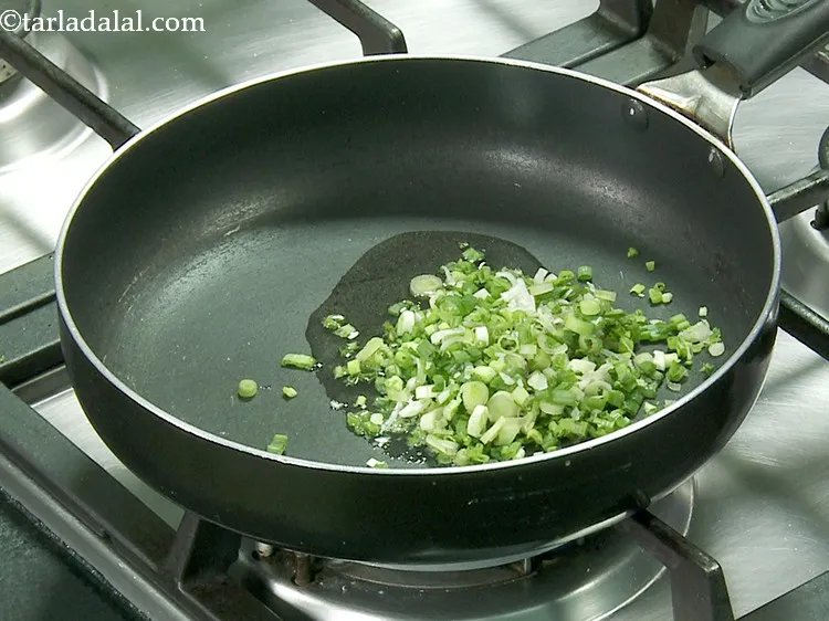 Step 28 – Once the oil is hot, add the spring onion whites.