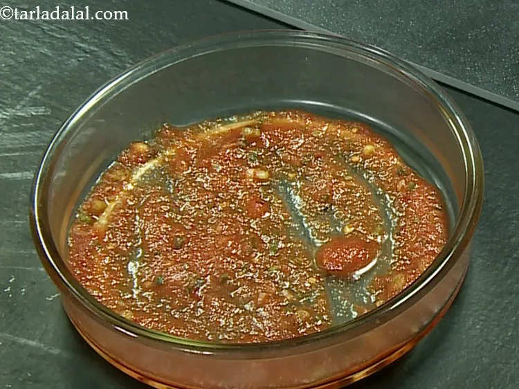 Step 40 – Pour &frac14; cup of prepared tomato sauce in a baking dish and spread it evenly.
