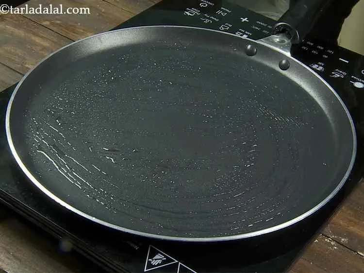 Step 14 – Heat a non-stick tava (griddle) and grease it with 1/4 tsp oil.