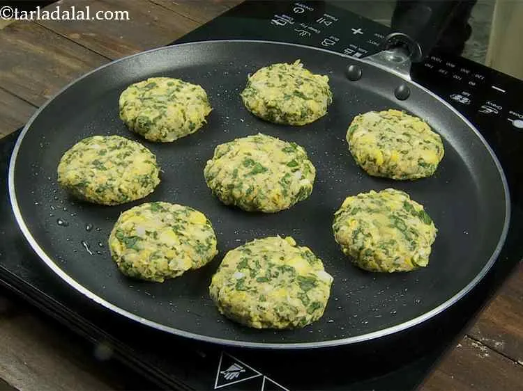 Step 15 – Once the oil gets hot, place the 8 <strong>corn methi tikkis</strong> on it and cook …