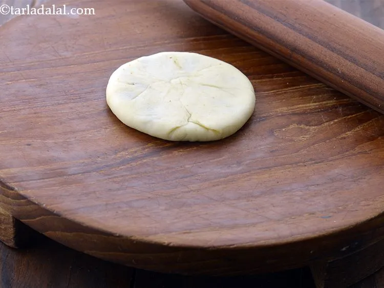 Step 34 – Roll a filled portion into a 75 mm. (3") diameter circle, ensuring that the filling …