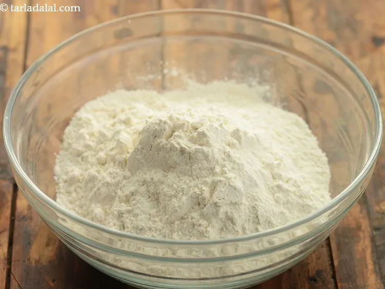 Step 5 – For the dough of corn kachori, add 2 cups&nbsp;<a href="https://www.tarladalal.com/glossary-plain-flour-maida-188i">plain flour (maida)</a> in a deep …