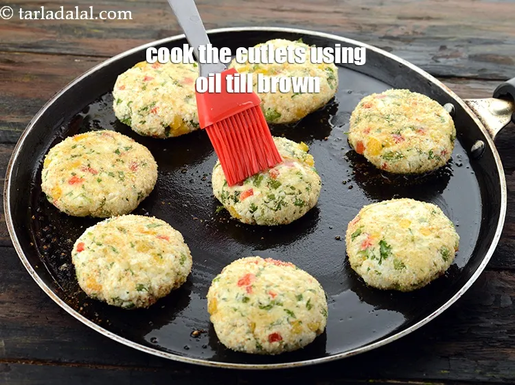 Step 24 – Cook the cutlets on it using 2 tsp <a href="https://www.tarladalal.com/glossary-oil-671i">oil</a>.&nbsp;