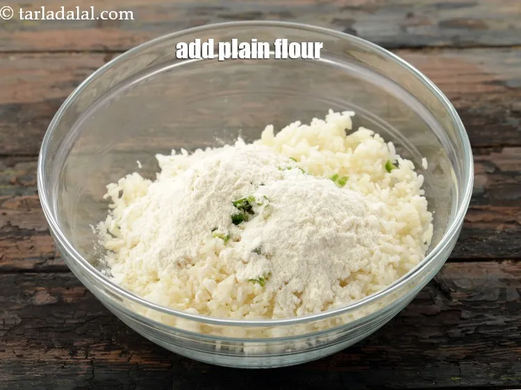 Step 11 – Add 1/4 cup&nbsp;<a href="https://www.tarladalal.com/glossary-plain-flour-maida-188i">plain flour (maida)</a> to give binding.&nbsp;