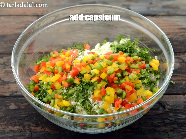 Step 13 – Add 1/2 cup&nbsp;finely&nbsp;<a href="https://www.tarladalal.com/glossary-chopped-capsicum-164i">chopped capsicum</a>&nbsp;(red , yellow and green) to make it look more colourful.&nbsp;