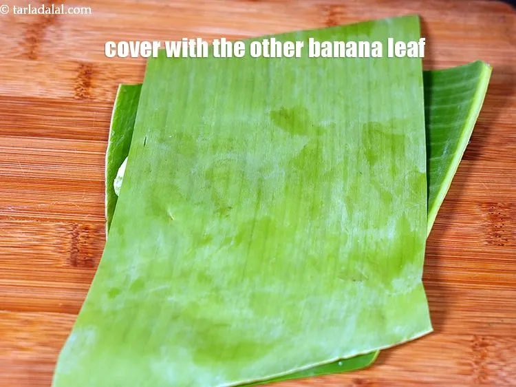 Step 21 – Place another banana leaf over it and press it lightly.