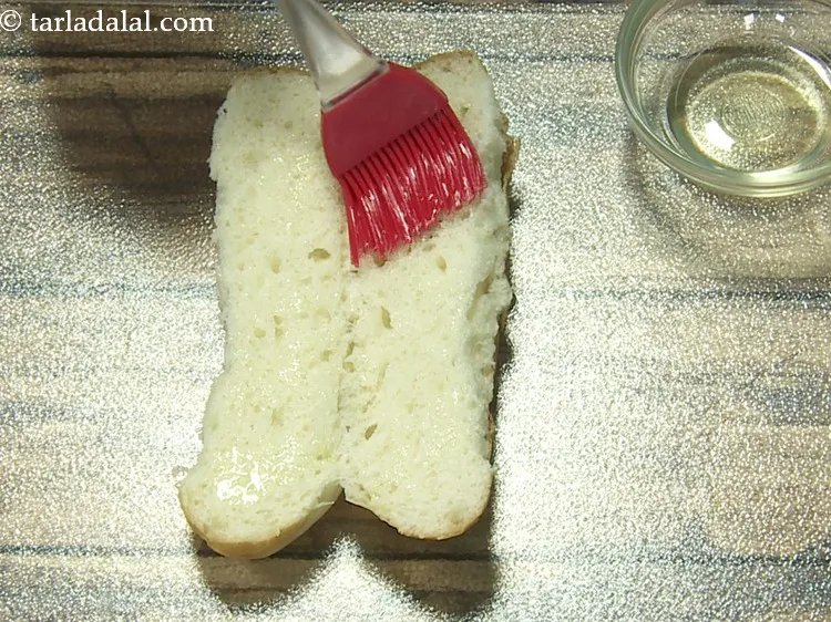 Step 14 – Apply &frac12; tsp of <a href="https://www.tarladalal.com/glossary-olive-oil-451i">olive oil</a>&nbsp;evenly on both the inner sides of the roll.