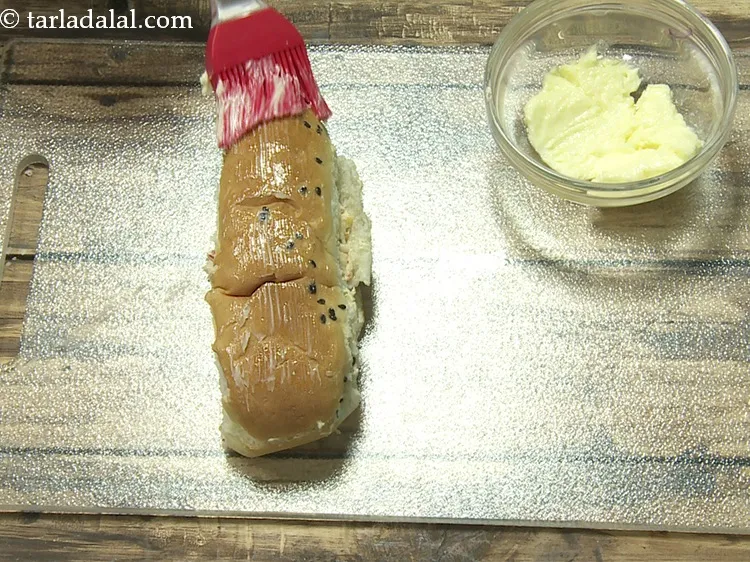 Step 17 – Spread 1 tsp of <a href="https://www.tarladalal.com/glossary-butter-makhan-233i">butter</a>&nbsp;evenly on top of it.&nbsp;