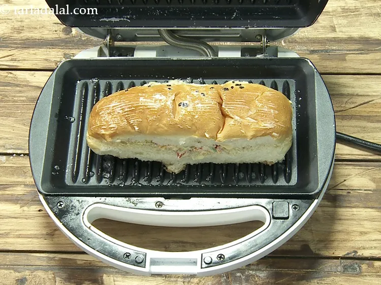Step 19 – Place it in the greased pre-heated sandwich griller.