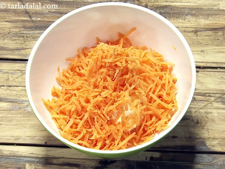 Step 4 – Add 1/2 cup&nbsp;<a href="https://www.tarladalal.com/glossary-grated-carrot-816i">grated carrot</a>.