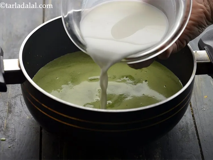 Step 20 – Transfer the sifted spinach puree to a kadhai. Add the cornflour-milk-cream mixture to the spinach …