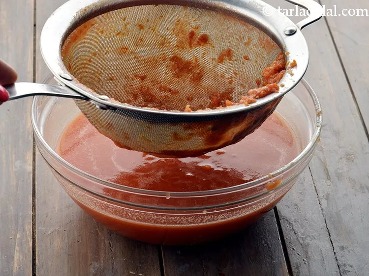 Step 10 – Strain it using a strainer to remove fibres and seeds from the tomatoes.