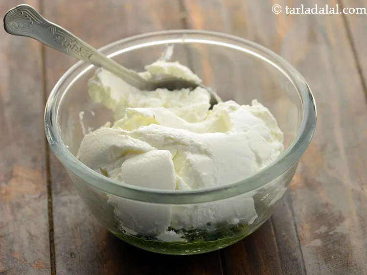 Step 11 – Add hung curd. Learn <a href="https://www.tarladalal.com/How-To-Make-Hung-Curd-42765r">how to make hung curd at home</a>.&nbsp;