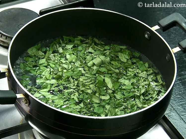 Step 14 – When the water starts bubbling vigorously, add basil.