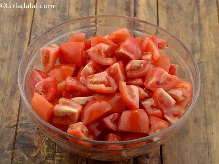 Step 3 – Clean and wash the tomatoes and cut them into big cubes.&nbsp;