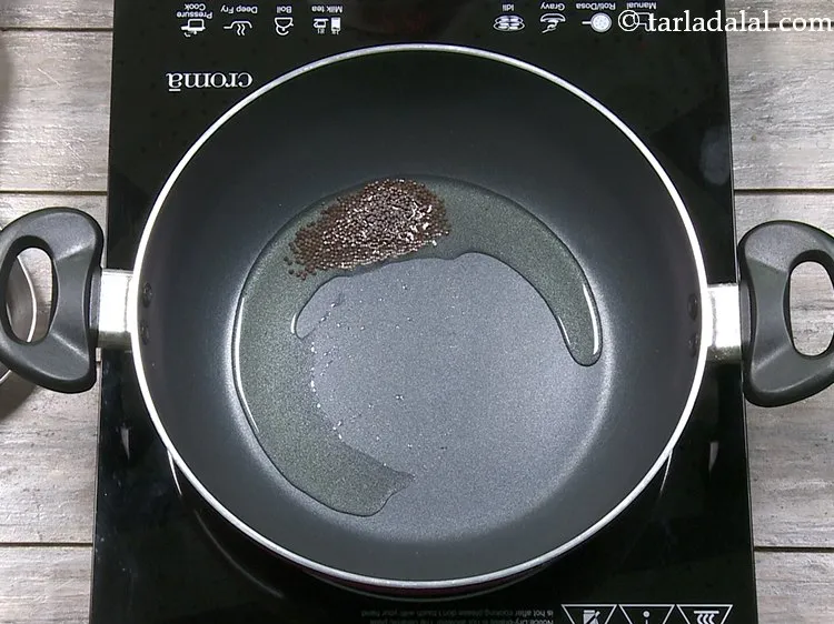 Step 7 – When the oil is hot enough, add the mustard seeds for tempering.&nbsp;