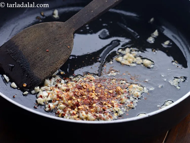 Step 5 – Add chilli flakes. You can adjust the quantity according to your preference of spice.&nbsp;