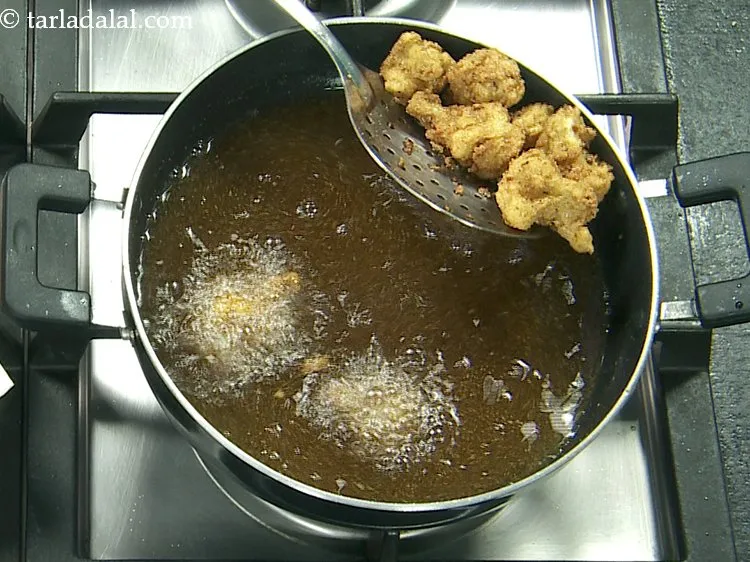 Step 19 – Deep-fry batter dipped cauliflower till they turn golden brown in colour from all the sides.