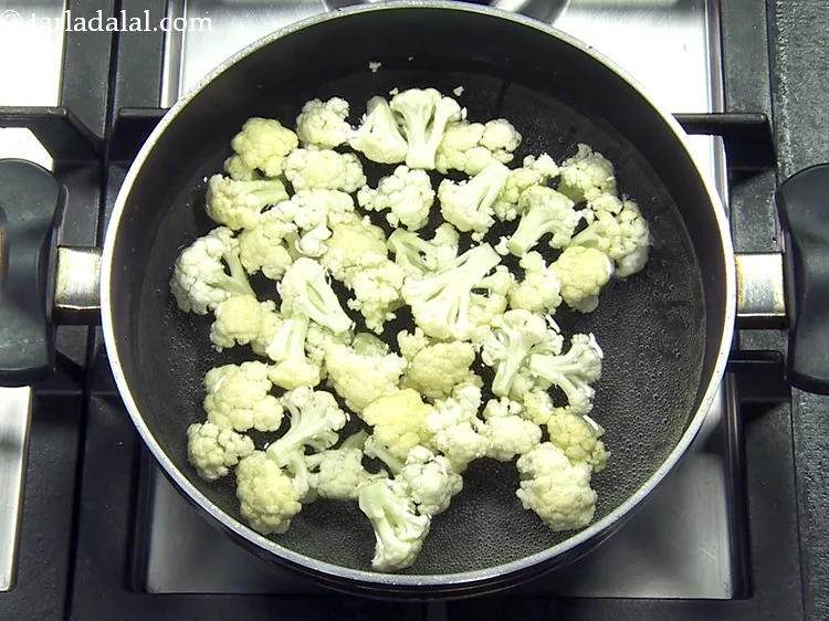 Step 8 – Carefully drop the cauliflower florets in it. Make sure you chop the cauliflower into bite-sized …