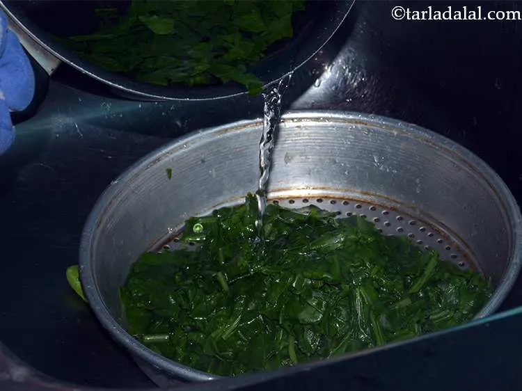 Step 7 – Drain the blanched spinach leaves.