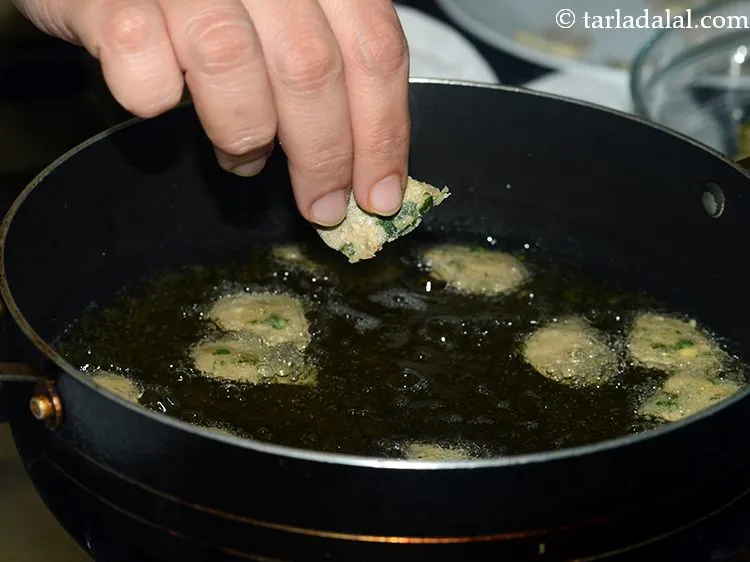 Step 23 – Heat the oil in a deep non-stick pan and add a few drops at a …
