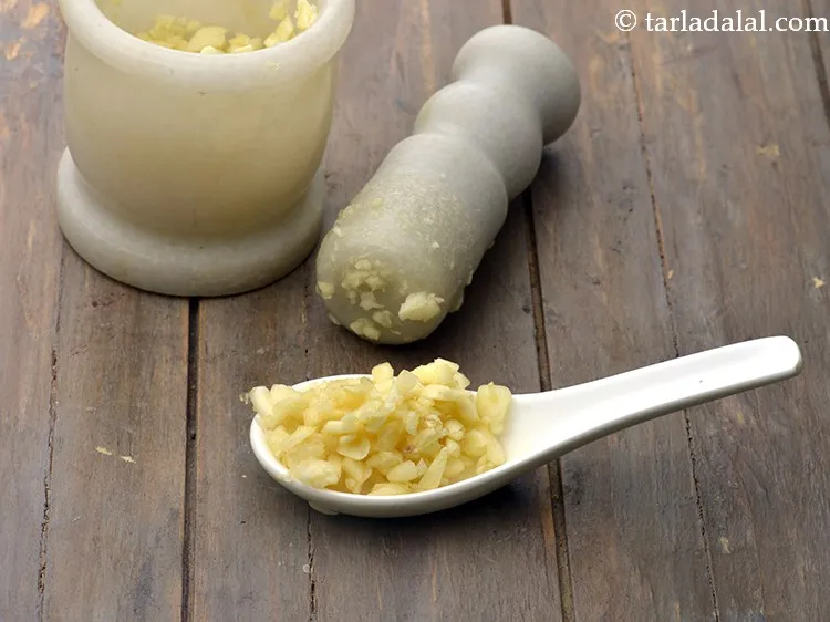 Step 17 – Add 5&nbsp;<a href="https://www.tarladalal.com/glossary-crushed-garlic-870i">crushed garlic (lehsun)</a>.