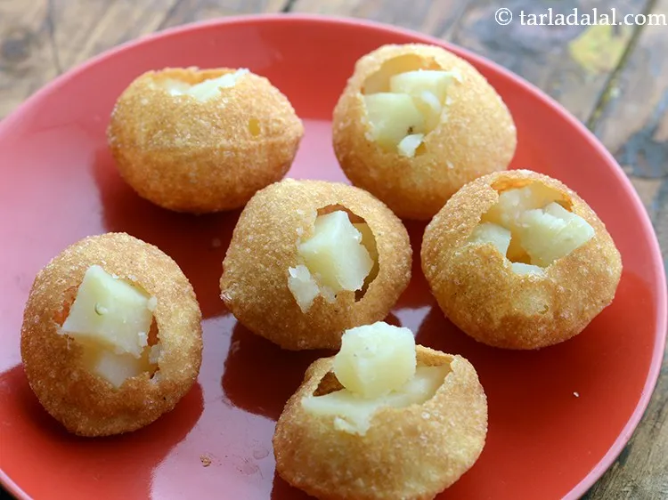 Step 4 – Stuff each puri with 1/2 tbsp of potatoes. IF you are a jain skip potatoes …