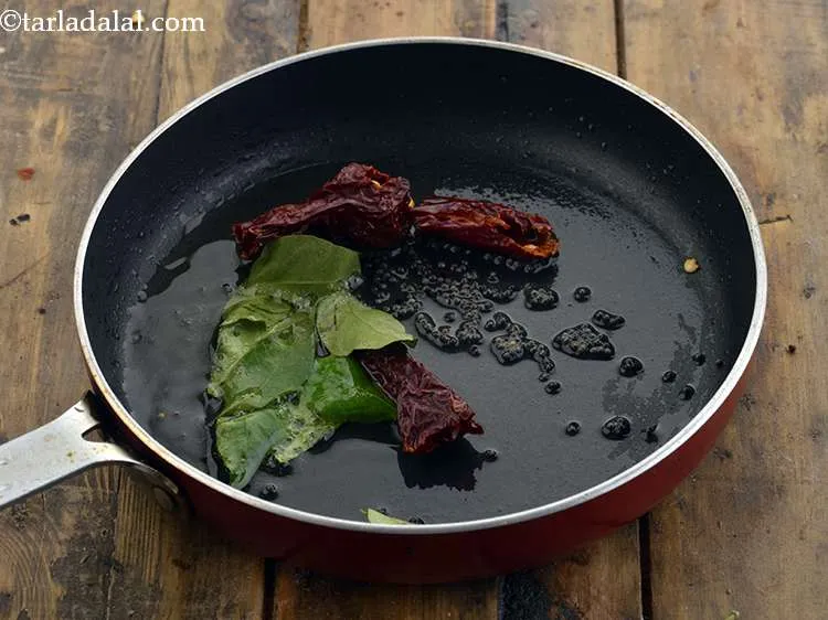 Step 12 – Quickly, add curry leaves and dry red chilies one by one and let them crackle. …