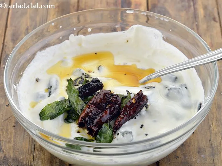 Step 13 – Pour this tempering immediately into the curd and Bhindi mixture.