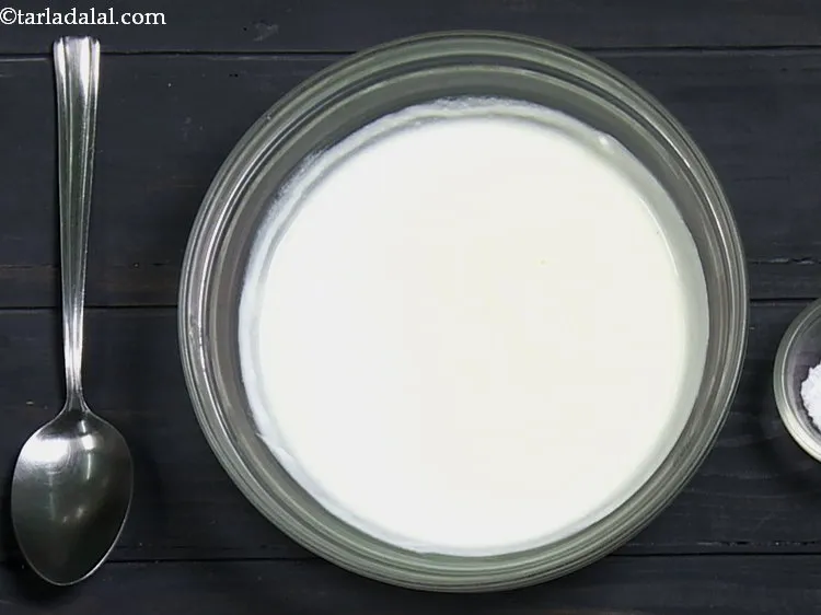 Step 2 – For making the <strong>dahi idli recipe</strong>, in a deep bowl, add the curd. We have …