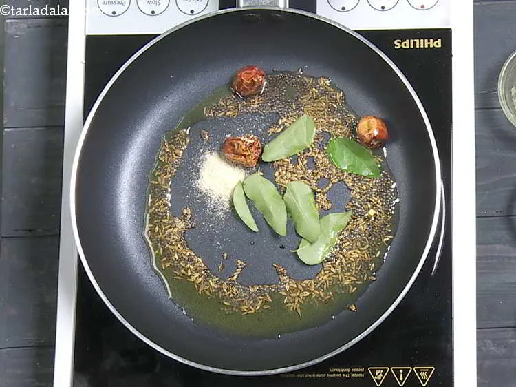 Step 8 – Add curry leaves and asafoetida.