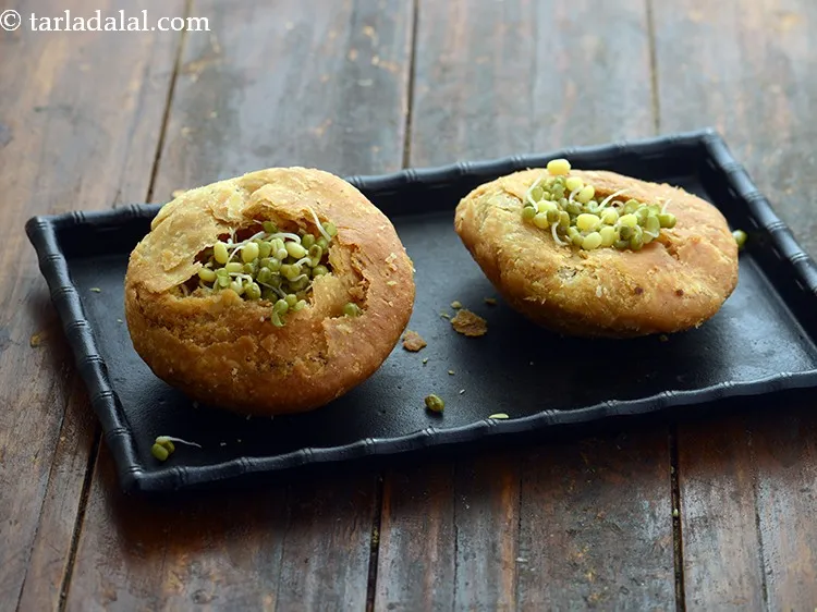 Step 44 – Put 1 tbsp of moong sprouts in each hole of the <strong>kachori</strong>.