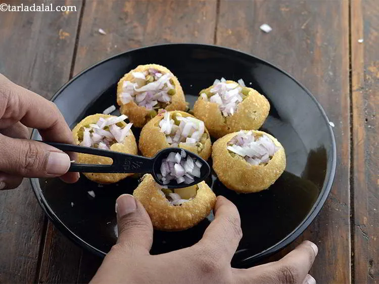 Step 13 – Put 1/2 tsp of finely chopped onions over the moong. One plate of Dahi Puri …