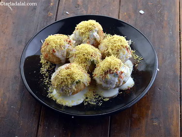 Step 20 – Generously sprinkle 2 tbsps of <em>sev </em>over the <em>puris</em> so as to completely cover them.