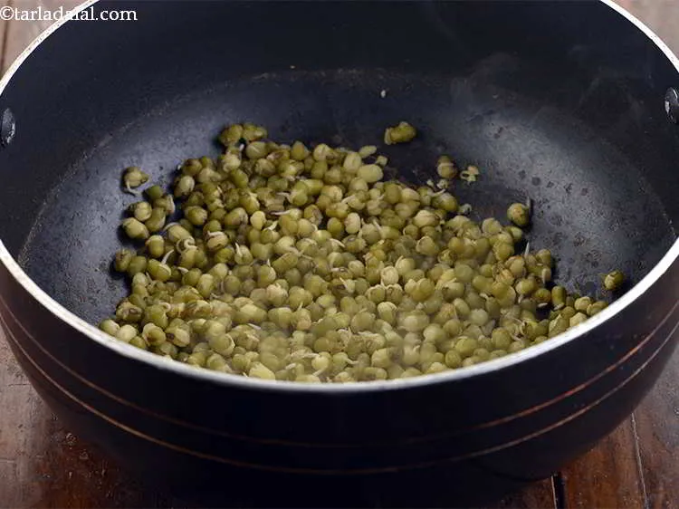 Step 6 – Cook the moong sprouts, covered with a lid, on a medium flame for 12-15 minutes, …