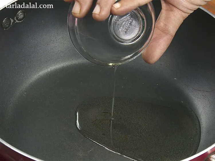 Step 10 – To temper the ragda, heat the oil in a deep non-stick pan.