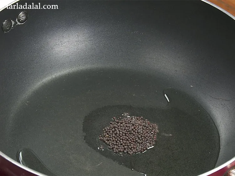 Step 11 – Once the oil is hot, add mustard seeds.