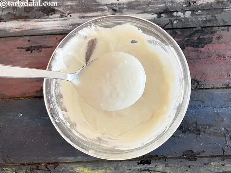 Step 18 – Take one portion of the batter in a spoon. Before that put a small portion …