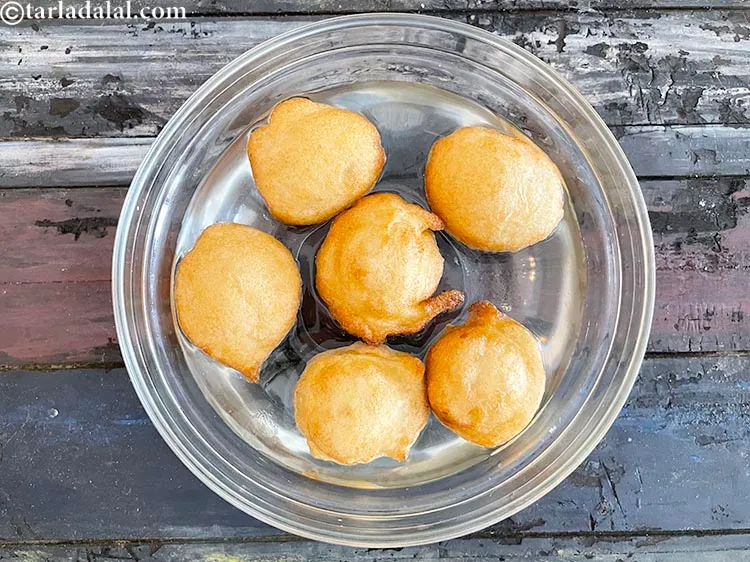 Step 28 – Take enough water in a deep bowl and soak the 6 vadas in it for …